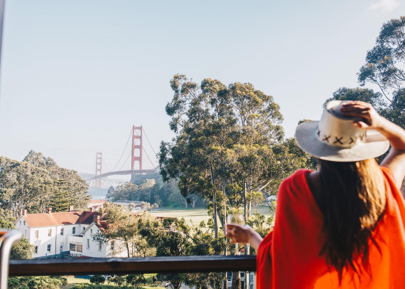 Woman enjoying the balcony view of the Golden Gate Bridge