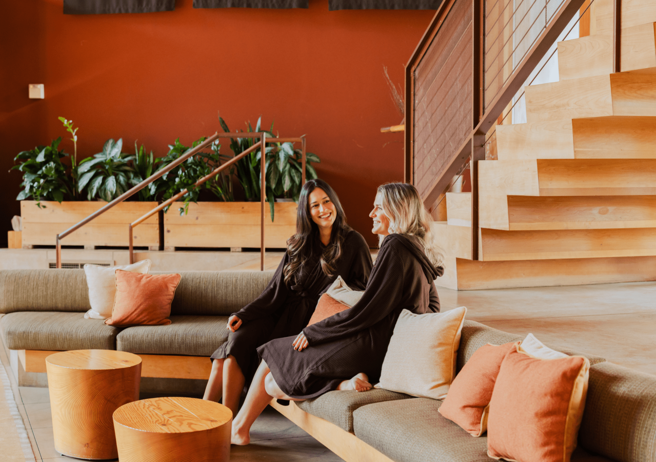 Two women sitting on couch at spa